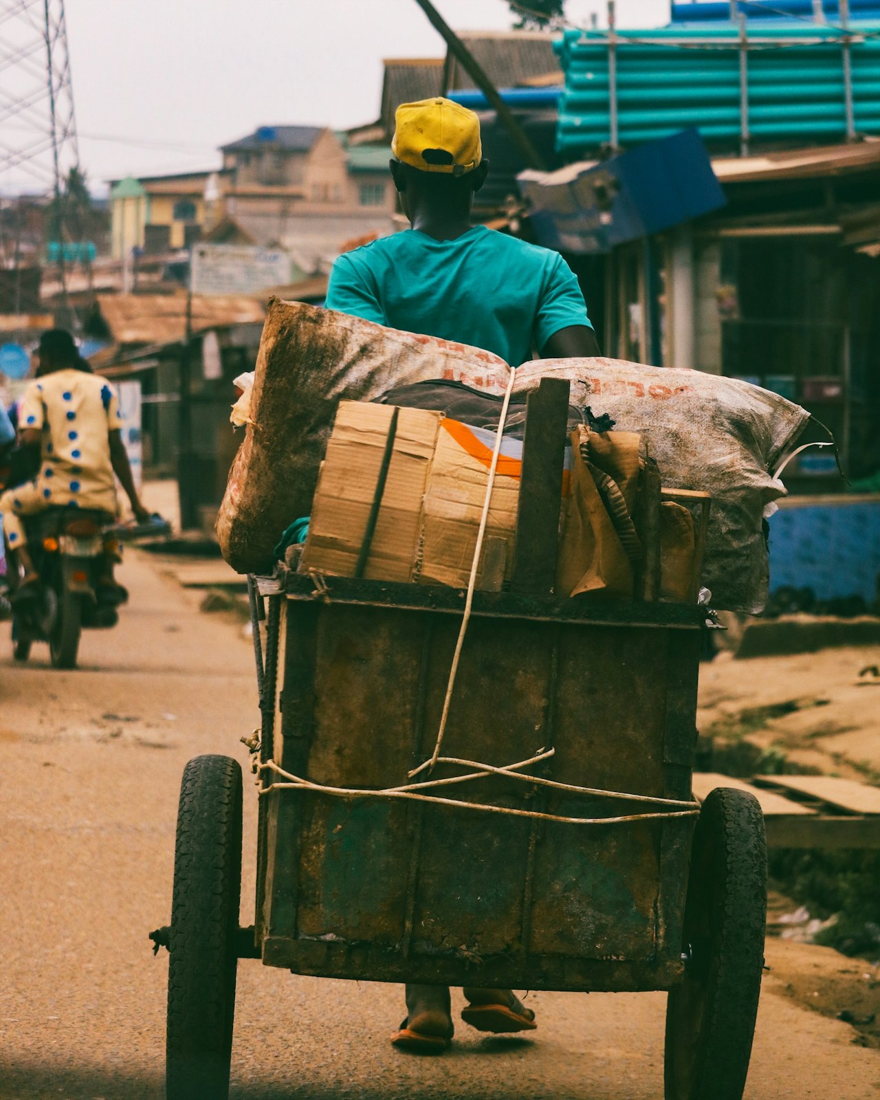 A cart loaded with goods on a dusty road