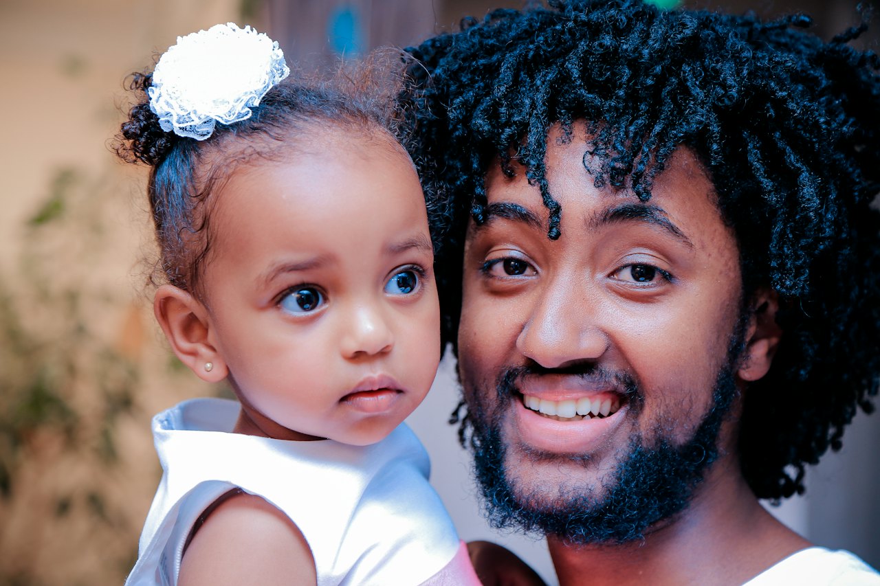 A father holding his little girl close