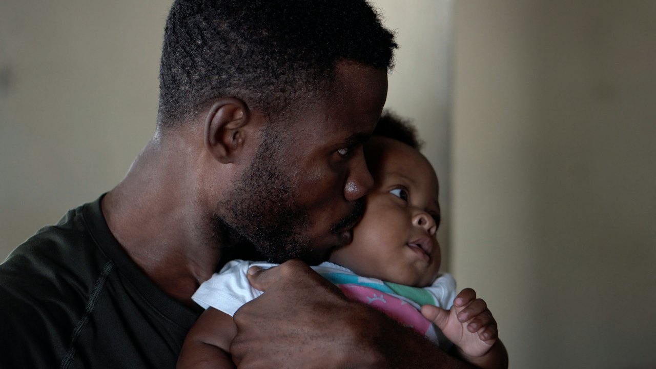 A father kissing his baby on the cheek