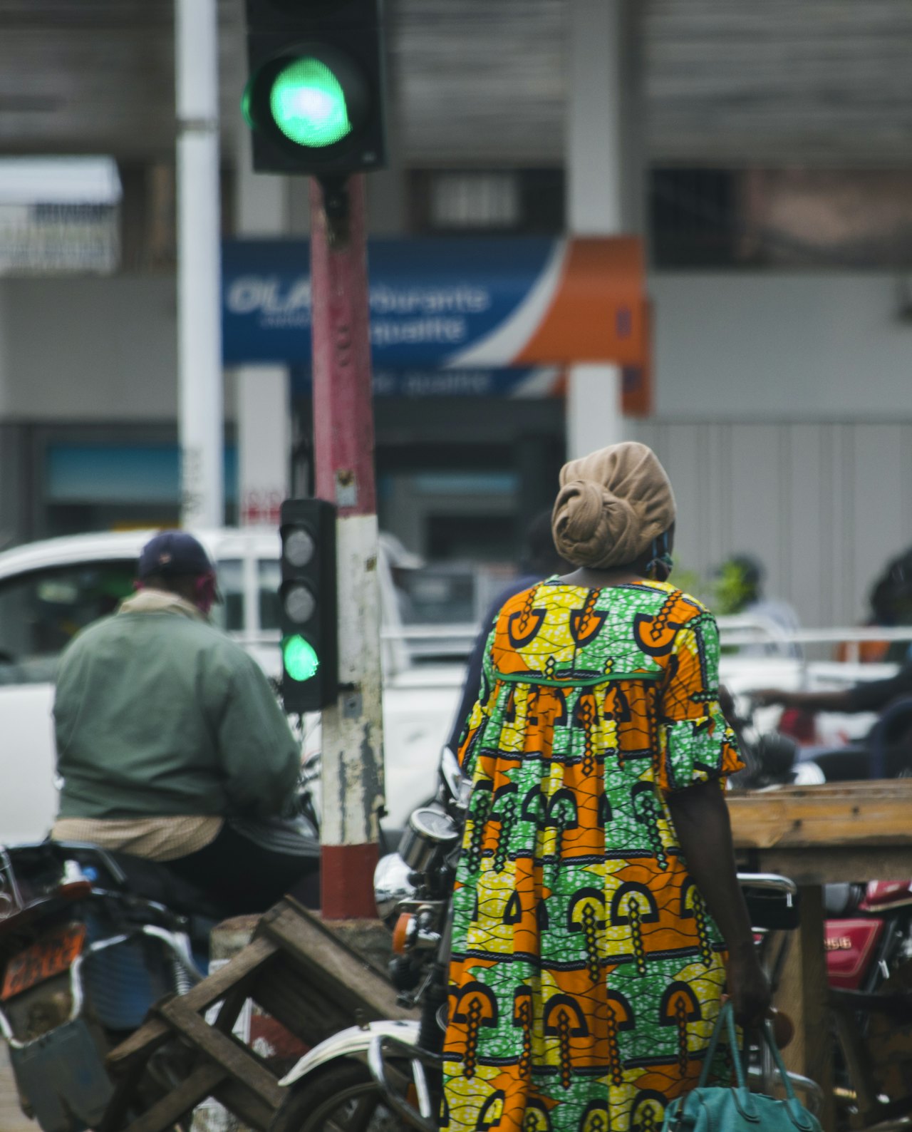 A woman in a colourful dress on a Cameroonian street